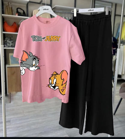 Pink t-shirt with Tom and Jerry design and black pants on hangers.